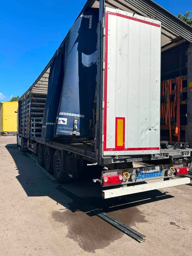 Rear of a Schmitz curtainsider trailer with doors open after loading at the Novatex yard in Tallinn